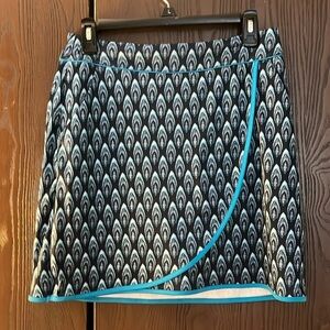 GN pull on golf skort. Black with turquoise feather design. Shorts are black. S
